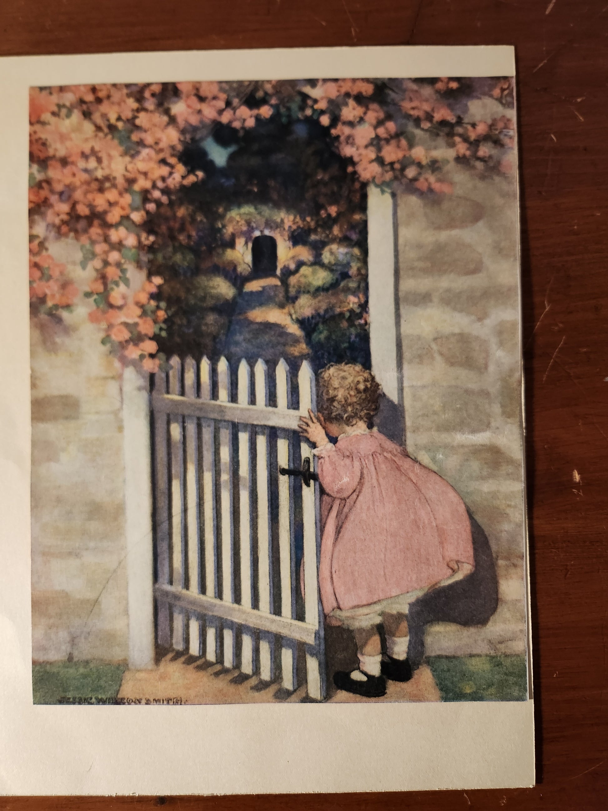 Vintage illustration of a girl peering into a garden by Jessie Wilcox Smith